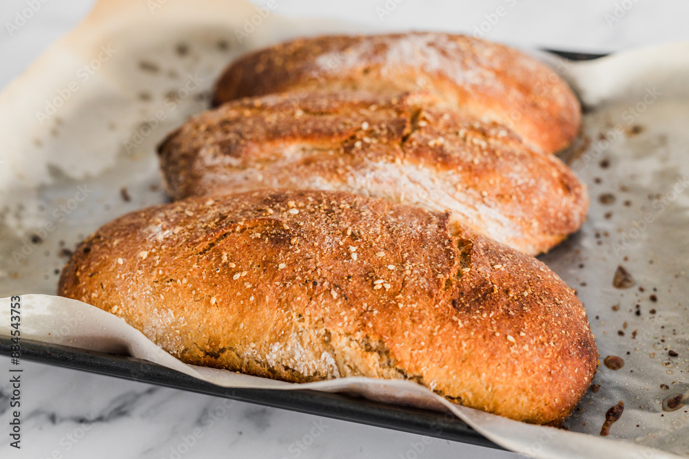 homemade rye bread baguettes on parchment paper