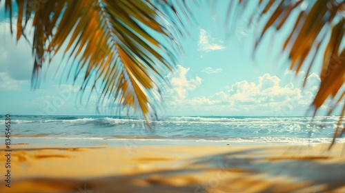 Stunning wide-angle view of a paradise beach with golden sand and palm leaves in blur  creating a summer banner