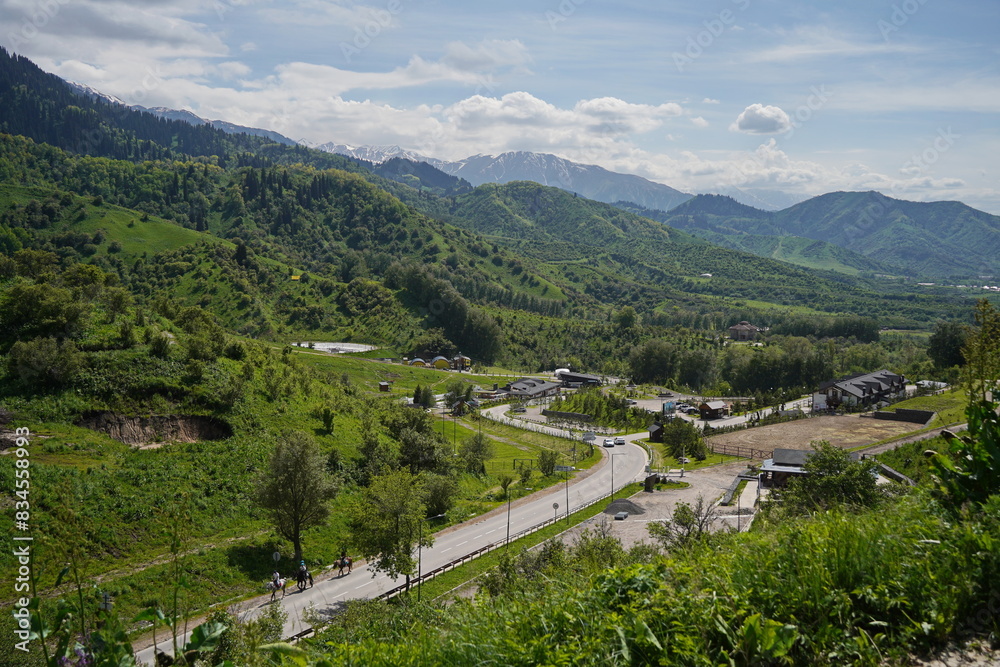 Naklejka premium Almaty, Kazakhstan - 05.22.2024 : An asphalt road in a mountainous area.