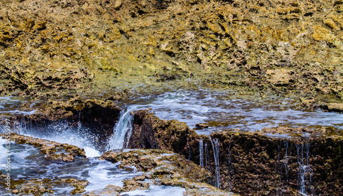 Waterfall on the rocks in the Caribbean Sea, Curaçao photo