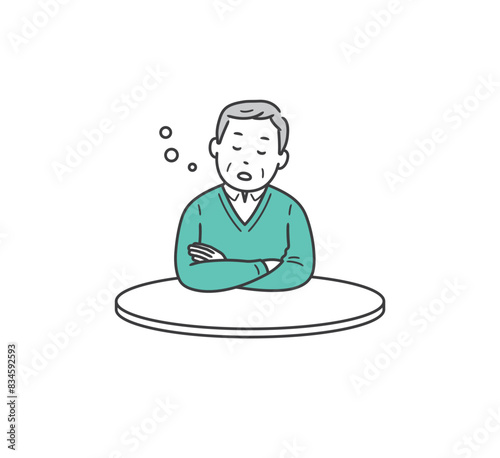 テーブルにもたれて居眠りをする高齢男性
