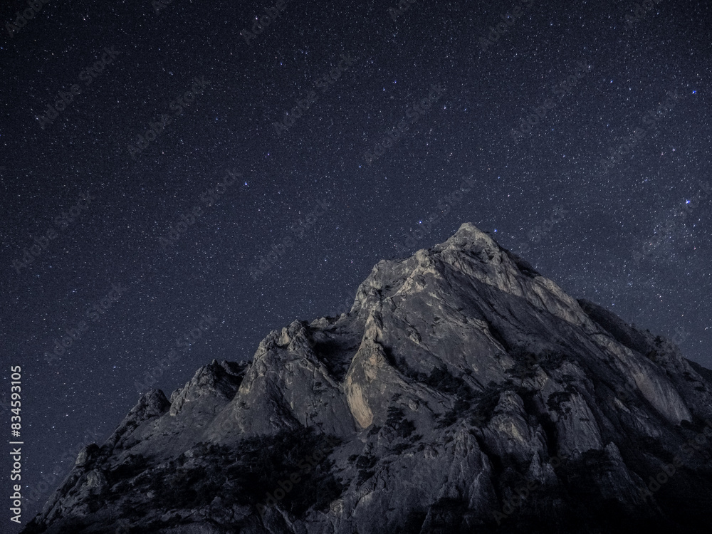 Rock under scarry sky at night astrophotography