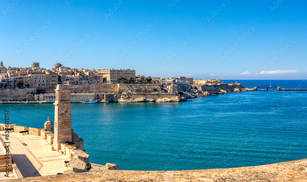 Fototapeta premium Fort St. Angelo, symbol of Malta's resilience, majestic stone walls, silent witness to rich history. Port in Birgu. View to Fort Saint Elmo. Cultural heritage of Malta