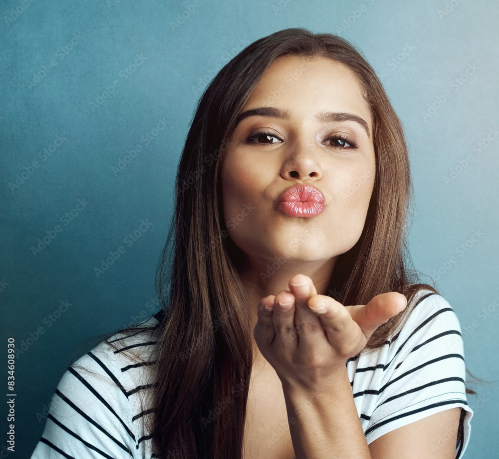 Blowing kiss, blue background and portrait of woman for romance, affection and gratitude in studio. Beauty, confidence and face of person with flirting emoji, positive hand gesture and thank you Blowing kiss, blue background and portrait of woman for romance, affection and gratitude in studio. Beauty, confidence and face of person with flirting emoji, positive hand gesture and thank you