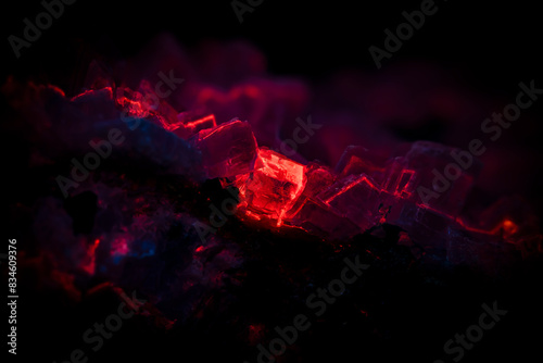 calcite under Short wave ultraviolet. Specimen From photography isolated on black background. macro detail close-up rough raw unpolished photo