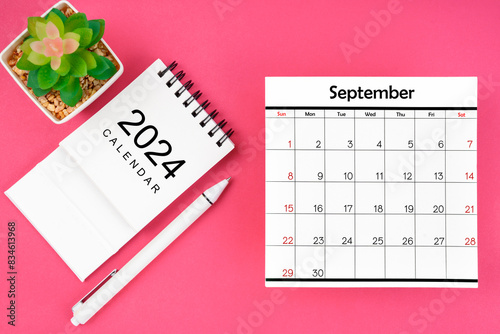 White calendar for Spetember 2024 and pen on pink color background. © gamjai