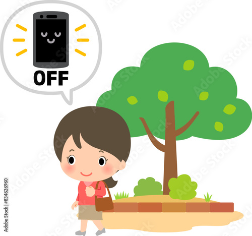 スマホの電源を切って公園を散歩する女性