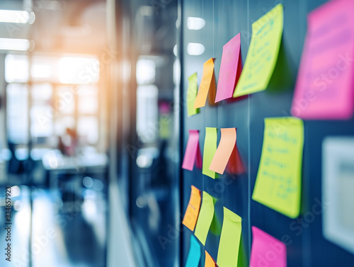 Colorful sticky notes on a glass wall, blurred office background, concept of brainstorming. Generative AI photo