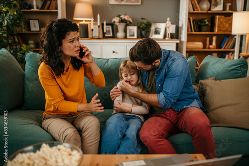 Worried mother call ambulance doctor, father hugging and take care of sick small child