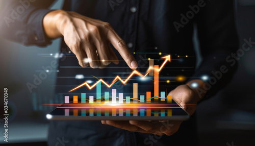 Businessman holding tablet displaying rising graph, Concept of financial growth and technology by AI generated image