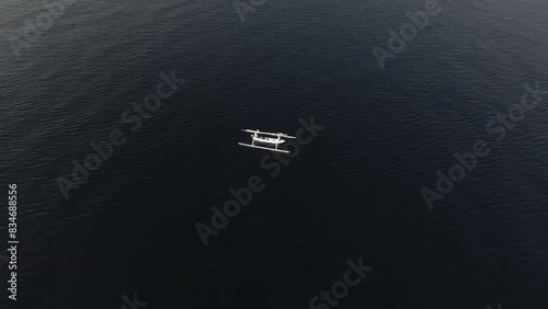 Arc shot of fisher boat on the ocean photo
