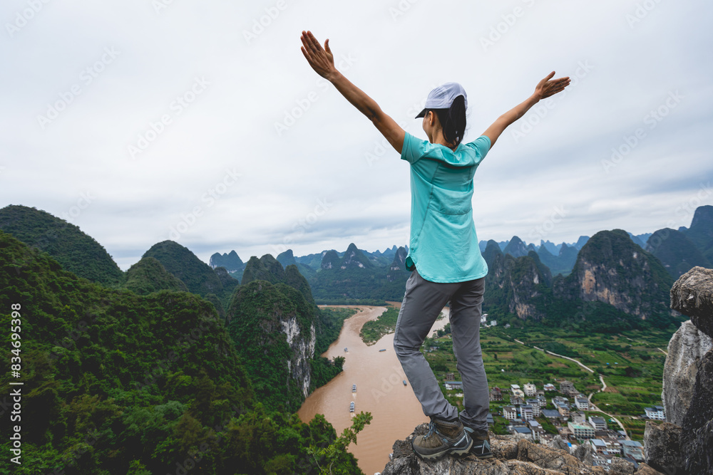 Woman tourist enjoy the beautiful landscape of yangshuo county, China Woman tourist enjoy the beautiful landscape of yangshuo county, China