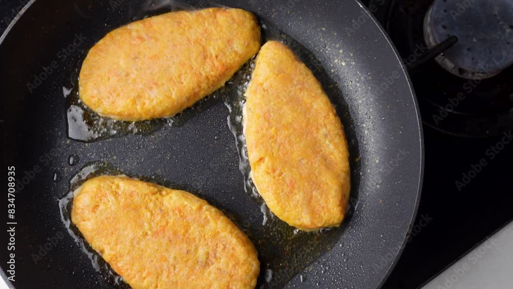 Fish cutlets sizzling in oil while frying in a pan on the stove. Concept of home cooking, traditional recipes, and culinary preparation. Fish cutlets sizzling in oil while frying in a pan on the stove. Concept of home cooking, traditional recipes, and culinary preparation.