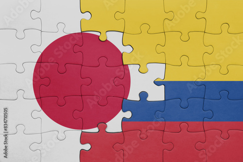 puzzle with the colourful national flag of colombia and flag of japan.