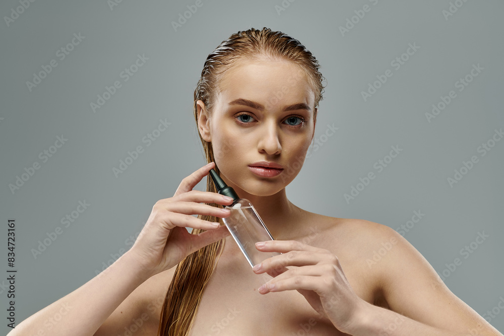 Obraz premium Beautiful lady with wet hair using hair care.