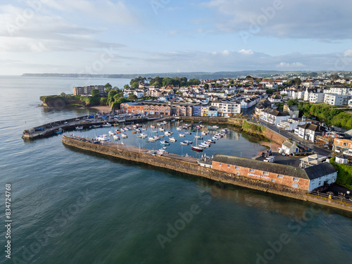 An aerial image of Paignton harbour on a clear sunny morning with blue skies and a calm sea
