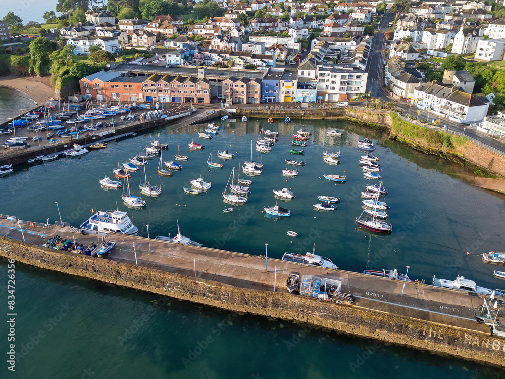 Naklejka premium An aerial image of Paignton harbour on a clear sunny morning with blue skies and a calm sea