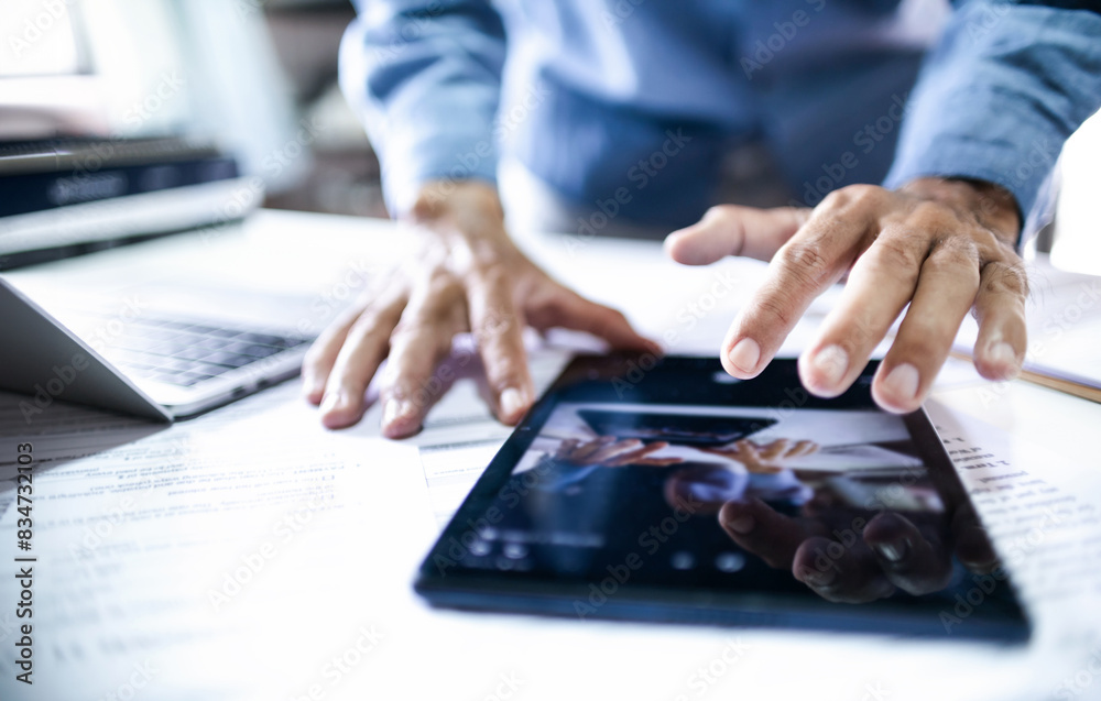 Asian businessman using tablet and laptop working at office, concept of use wireless connection technology via internet to working online Asian businessman using tablet and laptop working at office, concept of use wireless connection technology via internet to working online