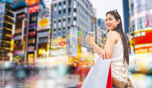 Photography Shopaholic asian woman with shopping bag and smartphone internet banking on back