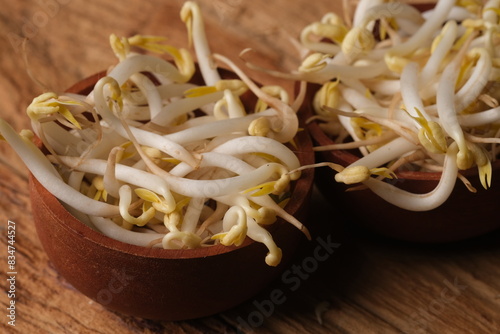 Mung bean sprouts are a culinary vegetable grown by sprouting mung beans. Bean sprouts in the wooden bowl. Tauge. Kecambah. photo