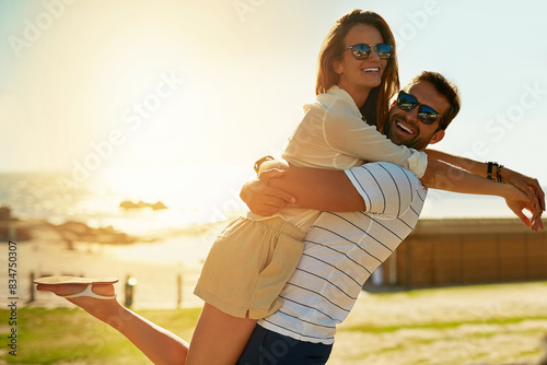 Hug, portrait and smile with couple on beach together for anniversary, date or romance in summer. Love, travel or vacation with happy man and woman embracing on tropical island paradise for honeymoon