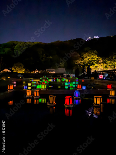 Colourful lanterns floating on the Koi pond beneath Matsuyama Castle photo