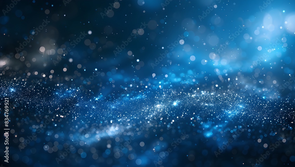 Fototapeta premium Abstract blue glowing particles background with a bokeh effect