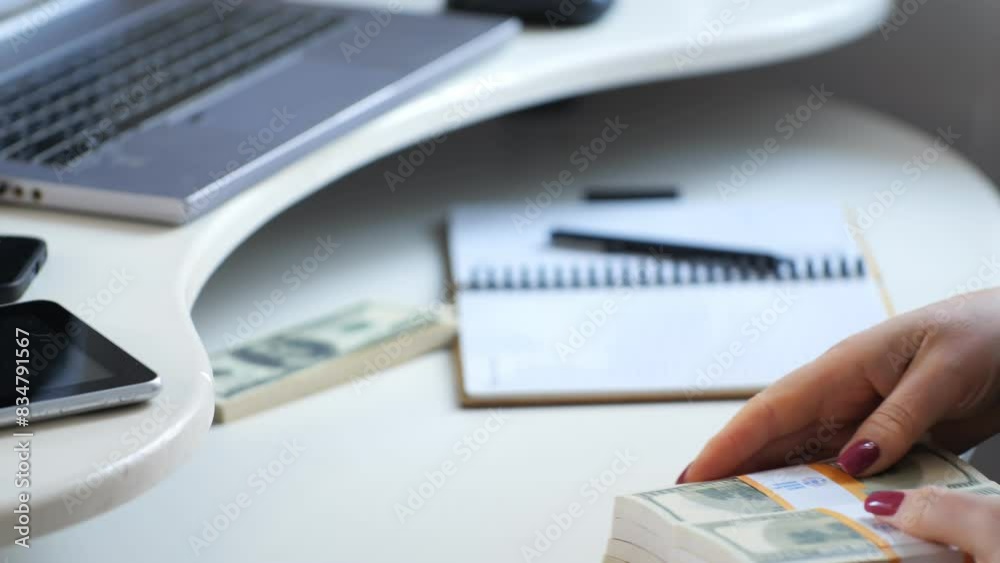 Person counting bundles of cash on an office desk, stacks of money in focus. Finance and economy concept. Person counting bundles of cash on an office desk, stacks of money in focus. Finance and economy concept.