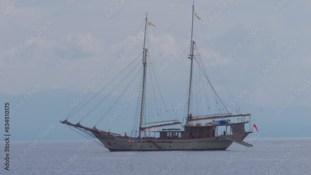 two-masted sailboat anchored near Kri Island, Raja Ampat, Indonesia. Static shot. two-masted sailboat anchored near Kri Island, Raja Ampat, Indonesia. Static shot.