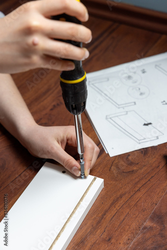 student assembling a piece of furniture