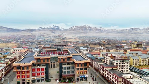Sertar city skyline, buildings in daytime, mountains in background, China Tibet landscape, aerial drone view photo