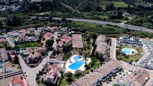Aerial view of architecturally-designed modern prestige homes with pools in outer suburban Spain