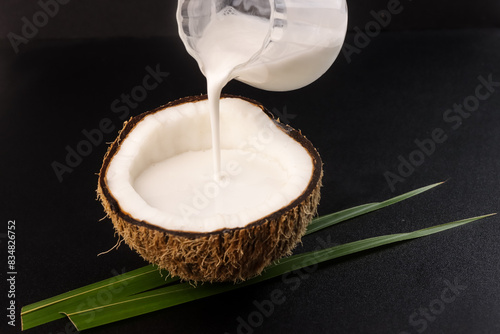 Coconut Milk with Coconut and Coconut Leaves. photo