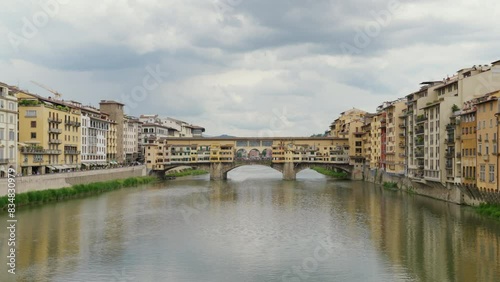 Serene view of the Ponte Vecchio bridge over Arno River in Florence.