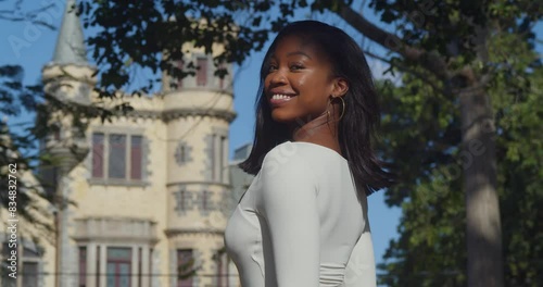 With Stollmeyer  castle in the background, a young girl in a white bodysuit enjoys her city day. photo