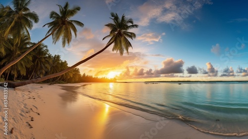 Scenic sunset over a tranquil tropical beach with palm trees and serene ocean waves.