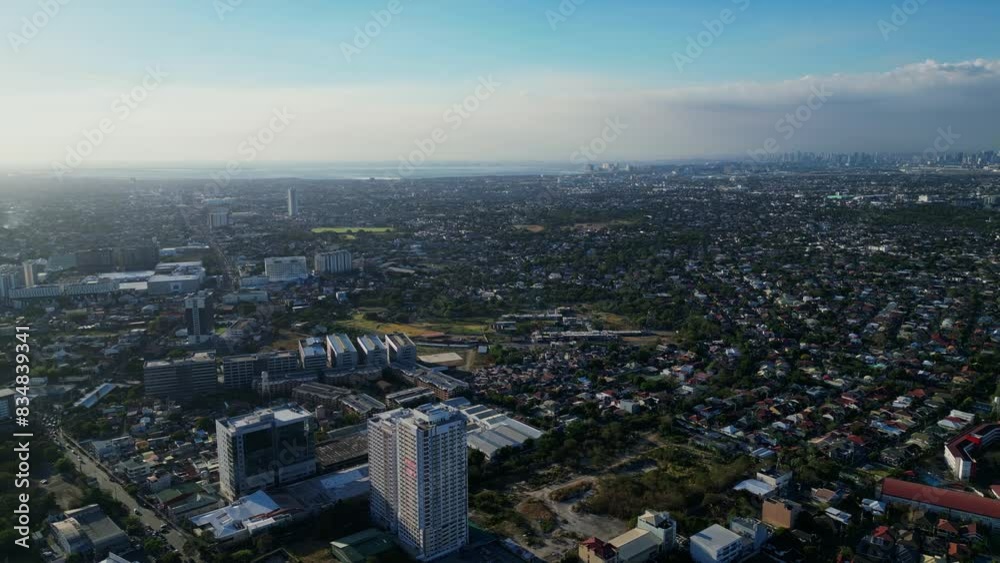 Stunning skyline over urbanized and densely populated Philippine city with modern buildings and subdivisions in Muntinlupa, NCR -aerial drone shot Stunning skyline over urbanized and densely populated Philippine city with modern buildings and subdivisions in Muntinlupa, NCR -aerial drone shot