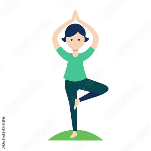 A woman is standing on one leg while doing a yoga pose