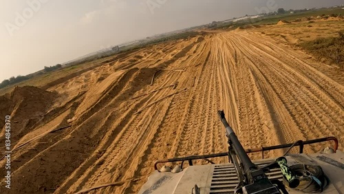 Israeli Humvee Patrol racing along a gravel rood through open country in Gaza photo