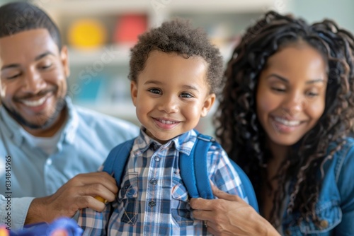 A close-up image of parents helping their child button up a school uniform shirt. The child looks excited and ready for school, while the parents show care and attention in their expressions. The photo