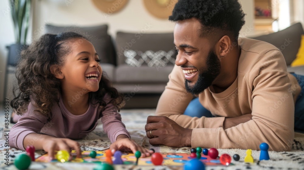 Family fun night, Father and daughter enjoying a board game. Family fun night, Father and daughter enjoying a board game.