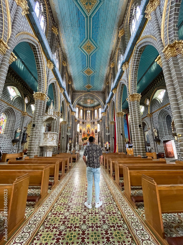Interior of Ornate Church with Visitor Admiring Architecture