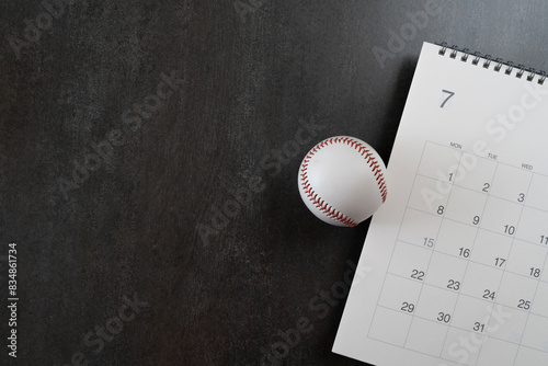 Fototapeta Naklejka Na Ścianę i Meble -  baseball and calendar on black background, top view sport concept