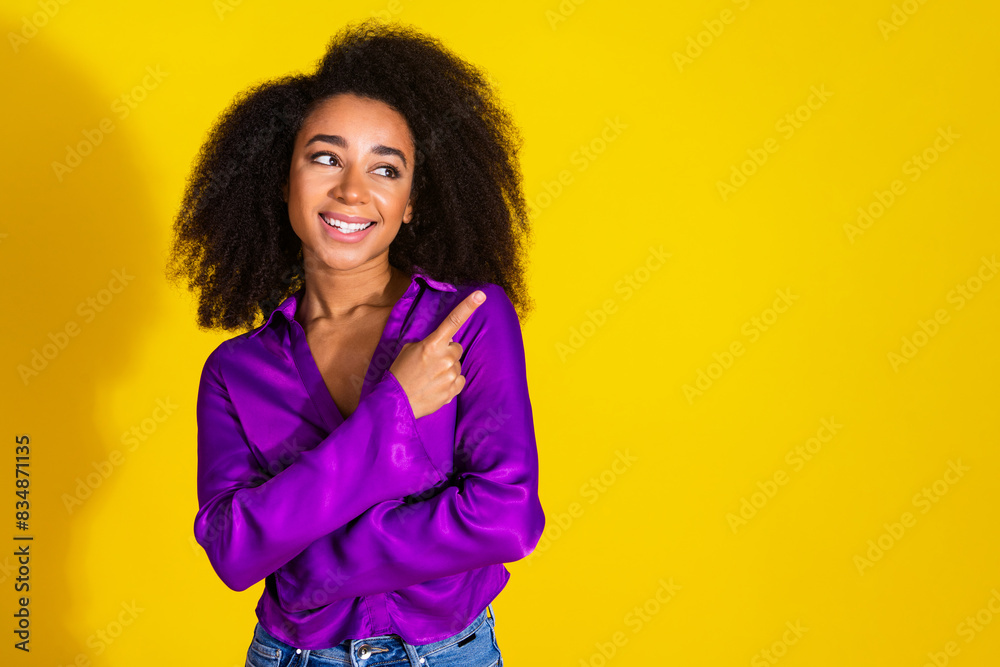 Photo portrait of attractive young woman look point empty space dressed stylish violet clothes isolated on yellow color background Photo portrait of attractive young woman look point empty space dressed stylish violet clothes isolated on yellow color background