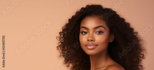 Beauty portrait of young African woman with curly hair, beautiful lovely model on studio background