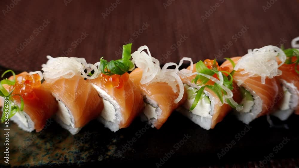 Close up of a Philadelphia sushi roll on a table at a restaurant Close up of a Philadelphia sushi roll on a table at a restaurant