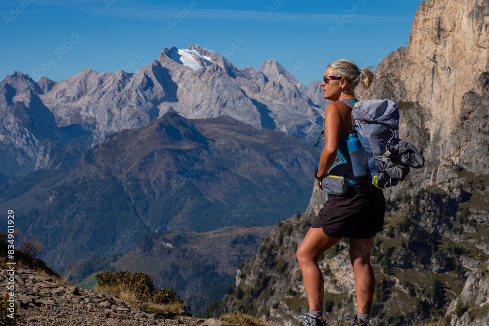 Naklejka premium Hiker Hiking the beautiful trails of the Dolomite Mountains near the Paso Giau and Mount Marmolada just outside the city of Cortina D'Ampezzo in the Dolomiti National Park