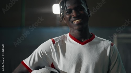 Professional football player training. A soccer player juggles a ball. Sports training is hard work. Sports green field for football. Positive man portrait with a beautiful smile. Concept sport. photo