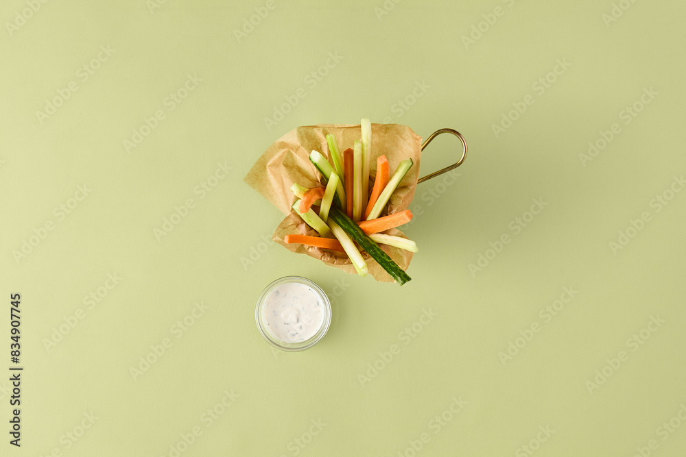 Fresh Vegetable Sticks with Dipping Sauce on Light Green Background Fresh Vegetable Sticks with Dipping Sauce on Light Green Background