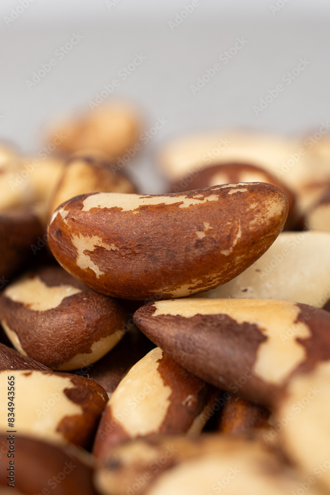 Macro brazil nuts on light grey background.